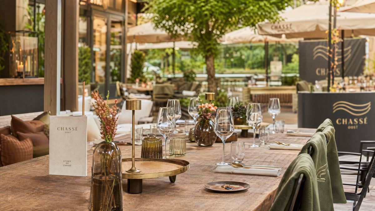 Tafelsetting met glaswerk, linnen en warme brasseriedetails.